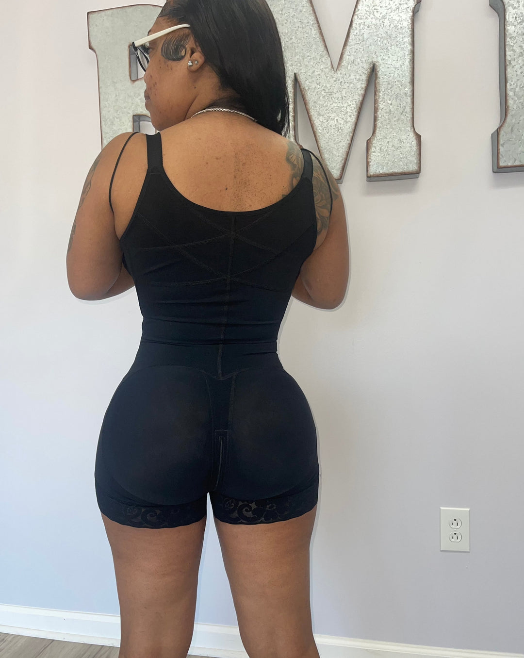 Black high back compression faja shapewear, back view showing seamless design